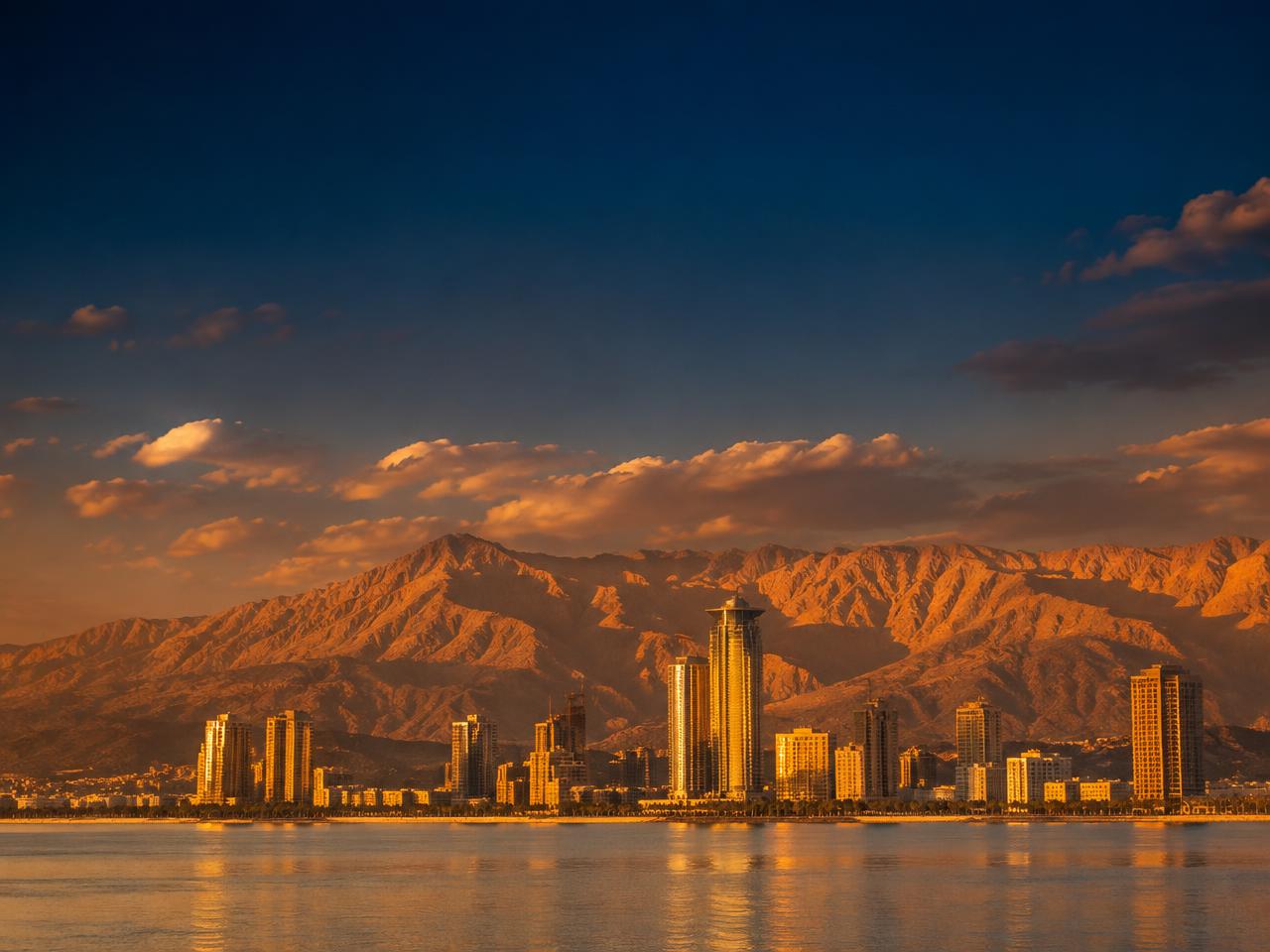 Ras Al Khaimah skyline with the Hajar mountains at sunset